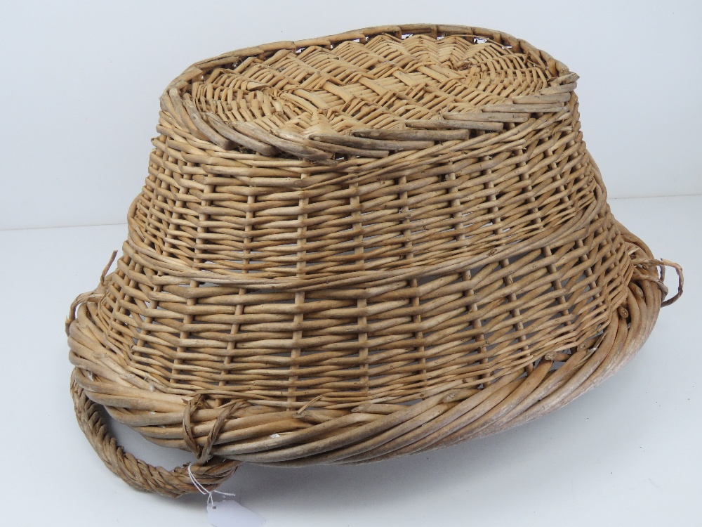 A wicker log basket of oval form having twin handles, measuring 59cm wide. - Image 2 of 3