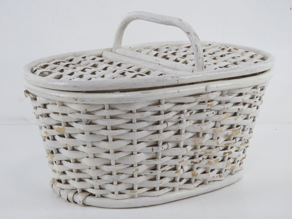 A small white painted vintage picnic basket with loop handle and hinged lid, 33cm wide.