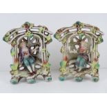 A pair of lattice ware ceramic figural garden floral encrusted seats with boy and girl upon,