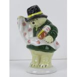 A Coalport figurine Paddington Bear 'Papers His Room' in green coat, standing 10cm high.