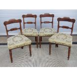 A set of four late 19th century mahogany framed dining chairs having double splat and ring turned