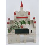 A vintage hand made castle dolls house, 28cm wide.