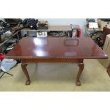 A good Edwardian mahogany extending draw leaf dining table raised over cabriole legs,