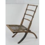 A Victorian wooden framed cane seated campaign chair, a/f.