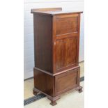 An Edwardian gramophone and music cabinet having twin slide shelves with fall front compartment