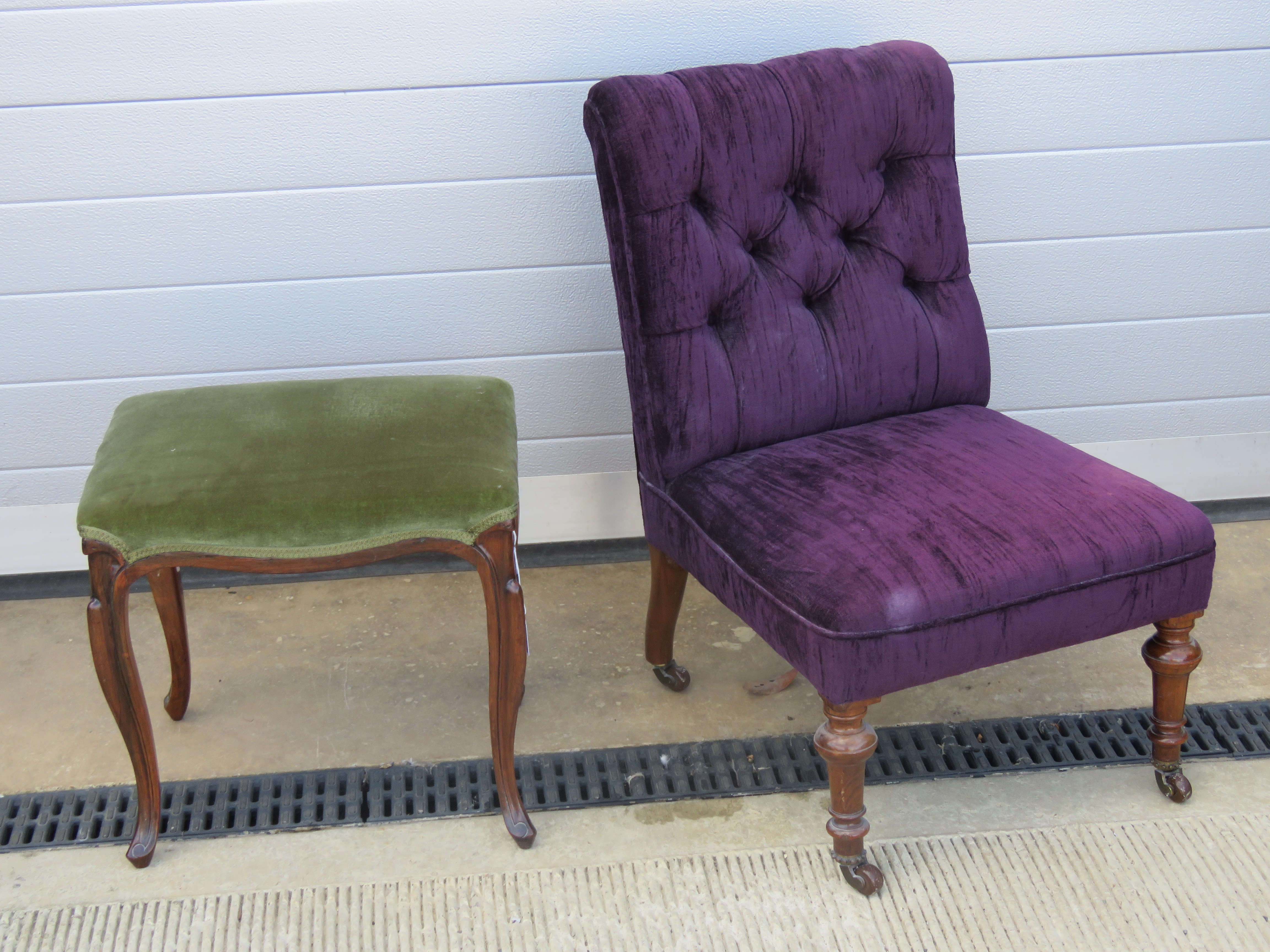A single four legged upholstered stool raised over slender shaped legs together with a button back