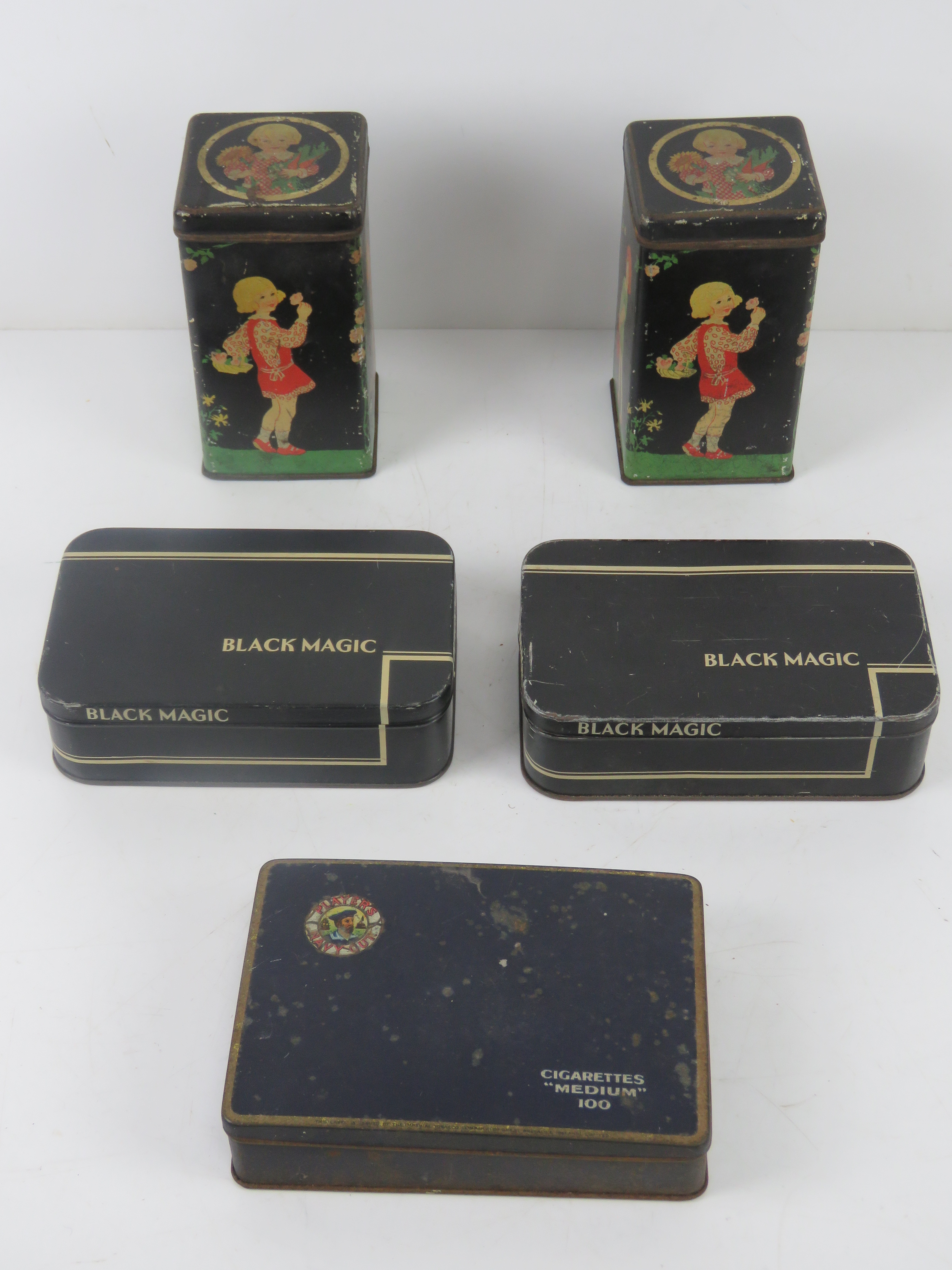 Two vintage tins having children gardening upon together with two vintage Black Magic chocolate