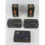 Two vintage tins having children gardening upon together with two vintage Black Magic chocolate