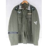 A reproduction WWII German Battle Tunic size XL.