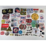 A quantity of assorted motor racing themed cloth patches and enamel badges,