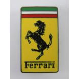 An enamel Ferrari pin badge.