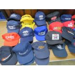 A large quantity of motor racing themed base ball caps.