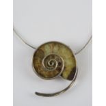A large and impressive silver mounted ammonite fossil having two pendant loops and