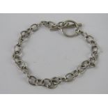 An HM silver charm bracelet having T-bar clasp, hallmarked 925 and measuring 18cm in length, 7.7g.