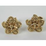 A pair of floral stud earrings having 9ct gold butterfly back, no apparent hallmarks to earrings, 1.