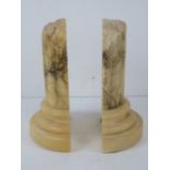 A pair of carved alabaster book ends in the form of Roman column bases, approx 20cm high.