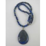 A teardrop shaped lapis lazuli pendant on beaded chain having 925 silver clasp,