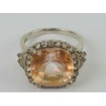 A silver and citrine cocktail ring, large central square cut peach coloured citrine, 14mm sq,