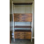 A c1960s walnut wall unit comprising various shelves and fall front cupboards, 93 x 36 x 200cm.