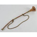 A copper and brass hunting horn measuring approx 42cm in length.