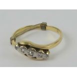 An 18ct gold ring having illusion set diamonds to the wrap style setting in white metal,