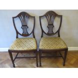 A good pair of Hepplewhite style shield back mahogany dining chairs, each with drop in seat.