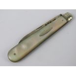 An HM silver and Mother of Pearl fruit knife, hallmarked Sheffield and measuring 12cm when open.