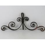 A piece of iron scrollwork for the top of a gate.