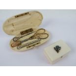 A late Victorian ivory etui opening to reveal gilt metal thimble, scissors (a/f),