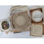 A quantity of handmade lace doilies together with a boxed set of vintage doilies showing houses of