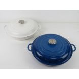 Two LeCruset casserole dishes in blue and white, each being 30cm dia.