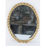 An oval bevel edged wall mirror in contemporary gilt frame approx 50 x 40cm.