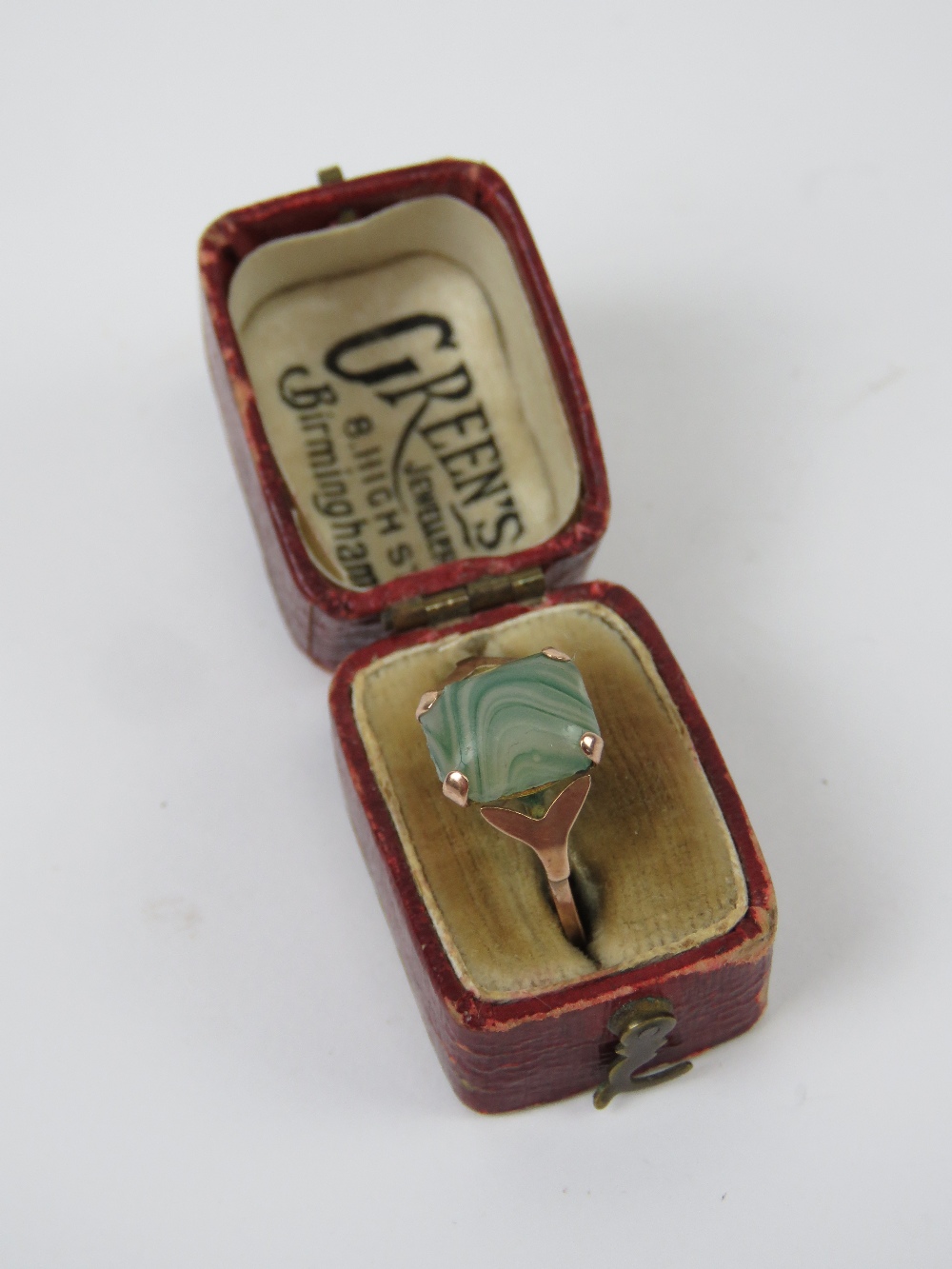 A vintage 9ct gold ring having unusual banded green stone ring, stamped 9ct, size O-P,