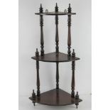 A contemporary mahogany three-tiered corner shelf 80cm high.