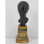 A bronze bust of a woman with elaborately braided hair after an antique model,