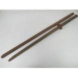 A wooden Bokken having Japanese characters hand painted upon,
