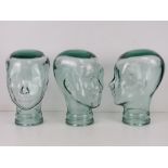 Three heavy glass 'mannequin' display heads, approx 30cm high.