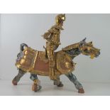 A handmade terracotta figure of a medieval knight on horseback, a/f, approx 58cm high.