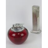 A silver plated Dunhill 'tallboy' Rollagas table lighter together with a Ronson red perspex table