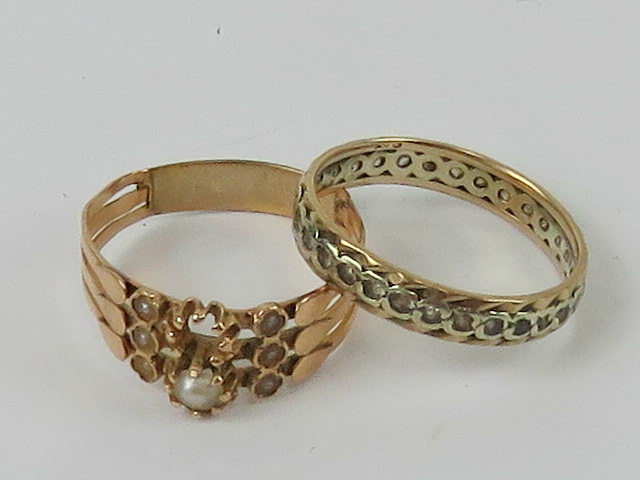 A Victorian rose metal ring set with seed pearls a/f, together with a 9ct gold eternity ring size M.