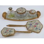 A mid-20thC dressing table set comprising perfume bottle, pots, tray, hairbrush and mirror.
