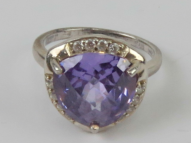 A silver cocktail ring having impressive central purple stone, stamped 925, size O-P.