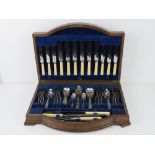 A quantity of silver plated and stainless steel cutlery inc carving set contained within oak