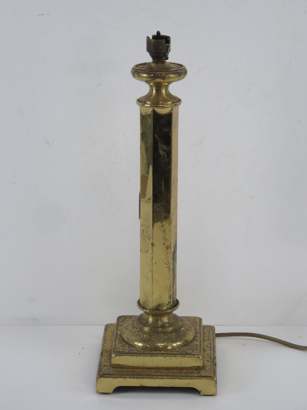 A brass table lamp having stepped base a