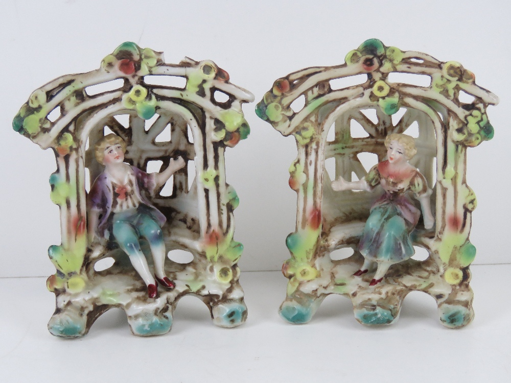 A pair of lattice ware ceramic figural g