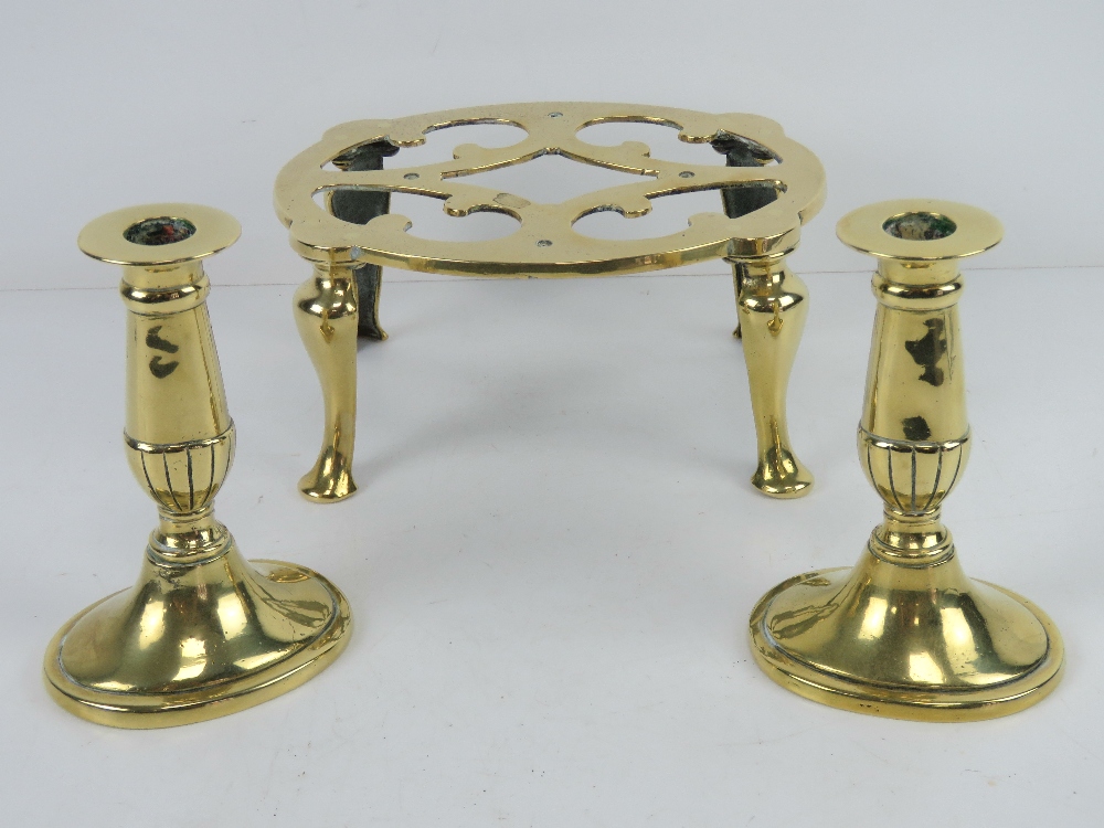 A good brass footman raised over four legs, 20cm wide,