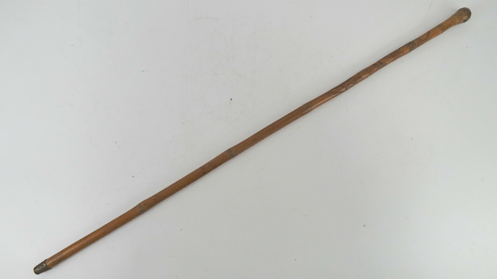 A bamboo swagger stick carved with birds