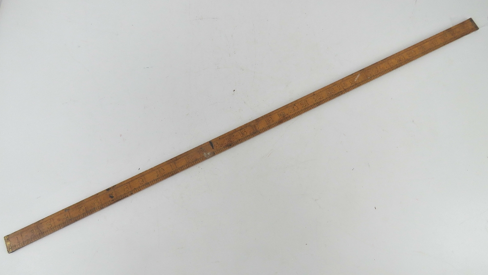 A boxwood yard stick having brass ends m