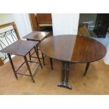 A mahogany drop leaf oval table raised o