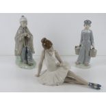 A Lladro figurine of a boy carrying twin
